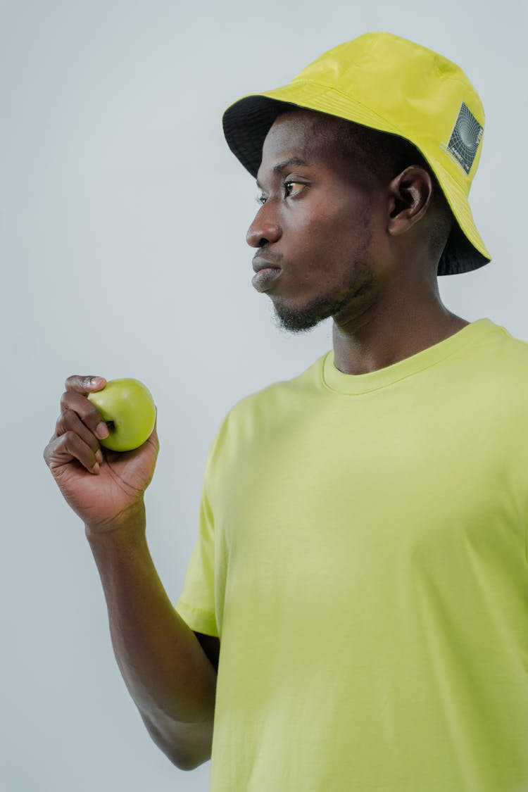 A Man Holding Green Apple