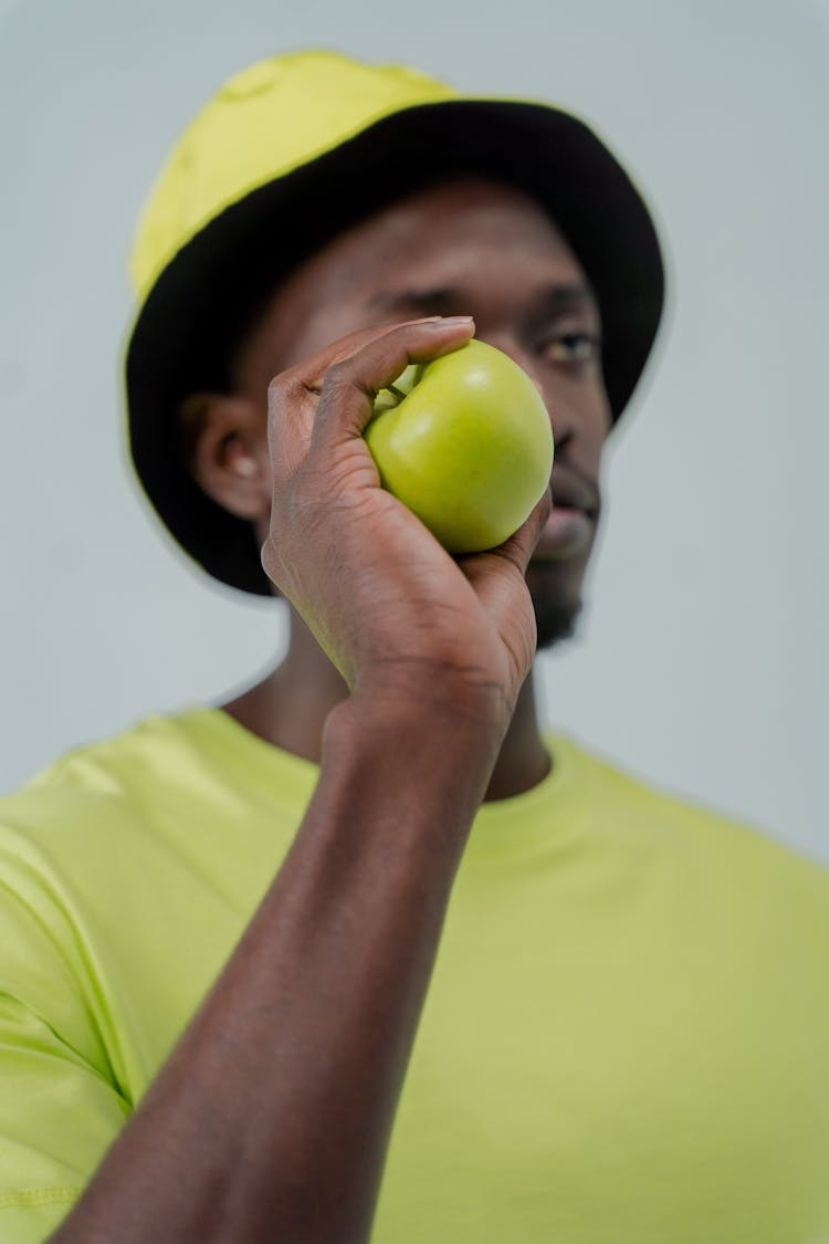 Close-Up Shot Of A Man Holding An Apple