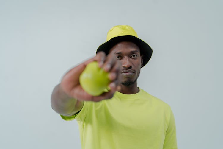 A Man Wearing A Bucket Hat And A Neon Shirt