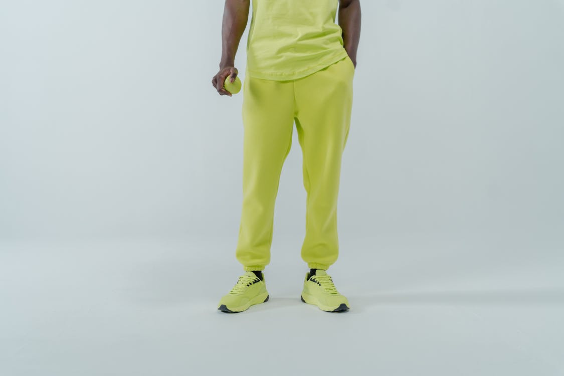 Person in Neon Green Pants and Neon Shoes Standing Near White Wall · Free  Stock Photo