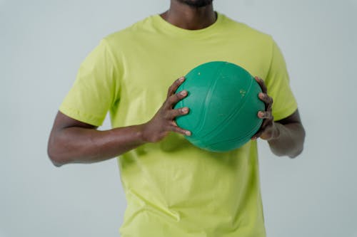 A Man Holding a Green Ball