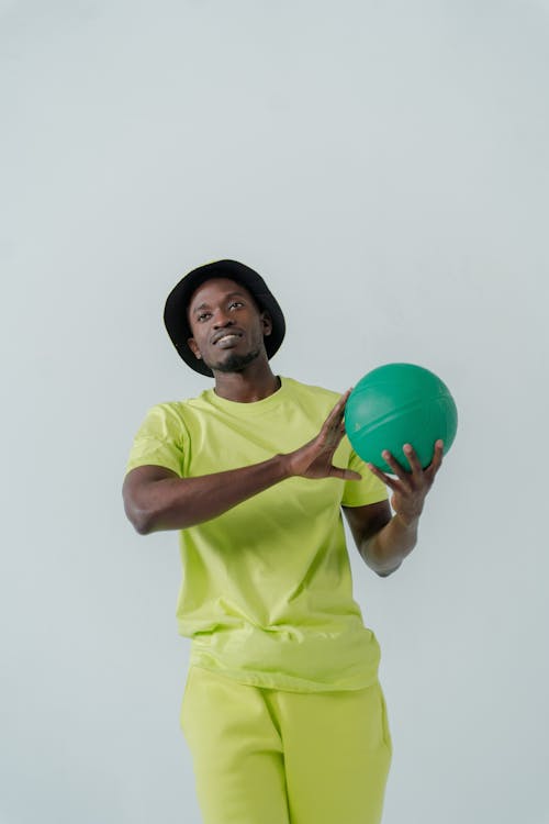 A Man Holding Green Ball