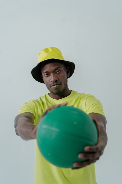 Close Up Photo of Man Holding a Ball