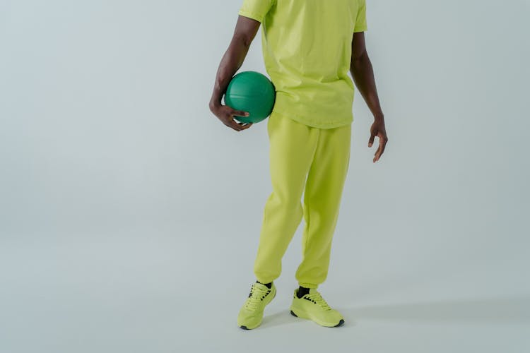 Man Holding A Ball While Standing