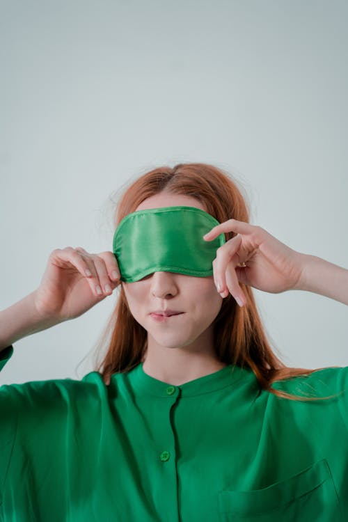 Sleepy Woman With Blindfolds On Eyes Stretching Stock Photo