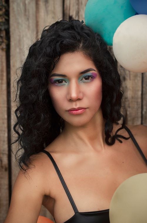 Free Close-up of stylish woman with vibrant eye makeup and balloons in Carcassonne. Stock Photo
