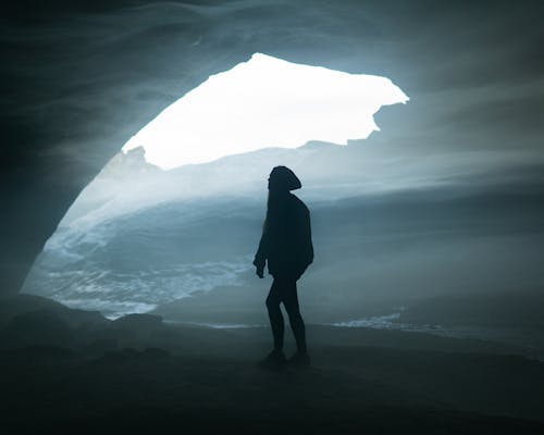 A Woman Standing in a Cave