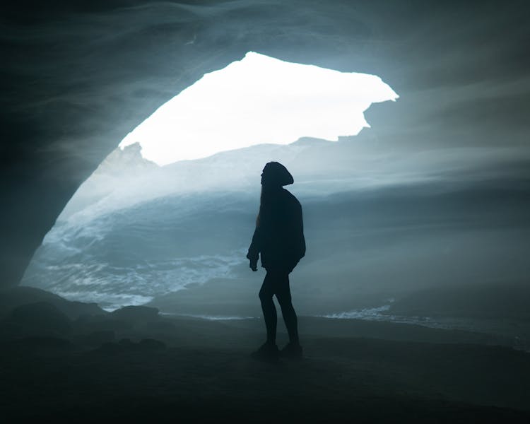 A Woman Standing In A Cave