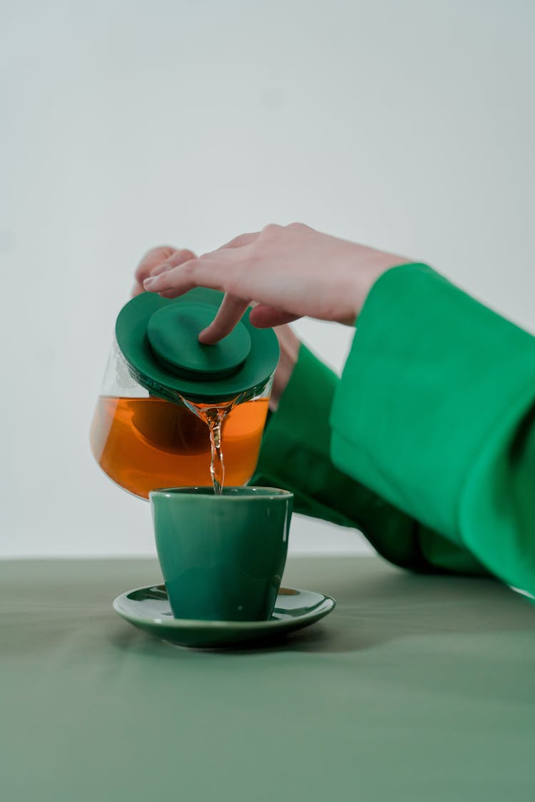 Pouring Tea On A Cup