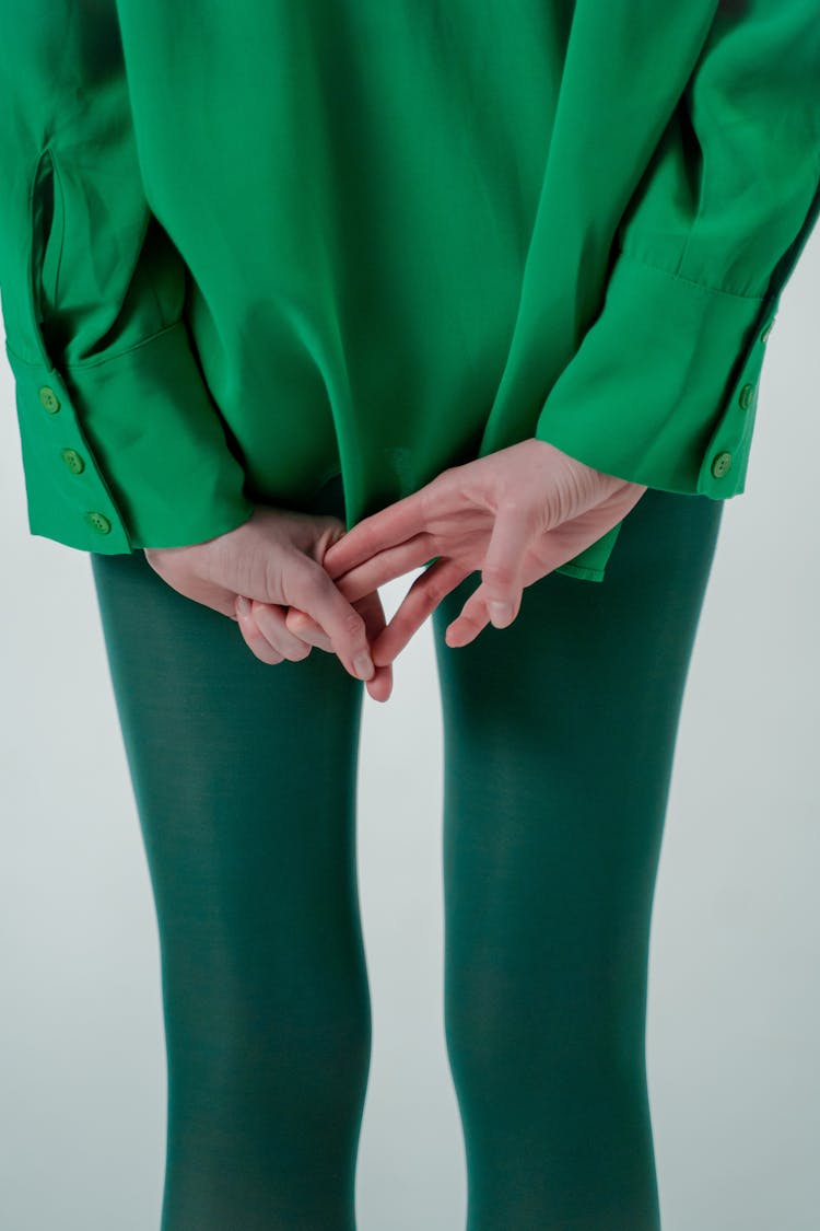 Woman In Green Clothes Making Gesture In Studio