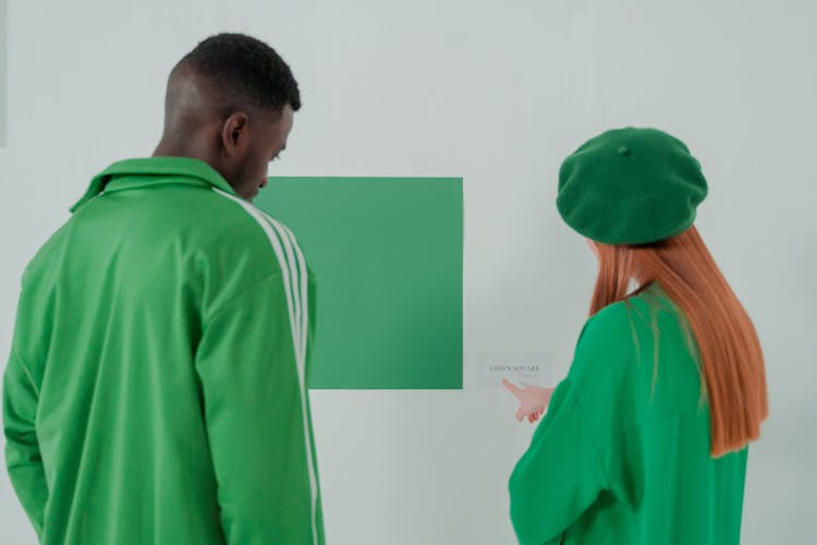 Couple Looking At Exhibition In Art Gallery 