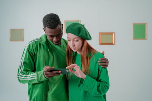 Couple Wearing Green Clothes in Art Gallery 