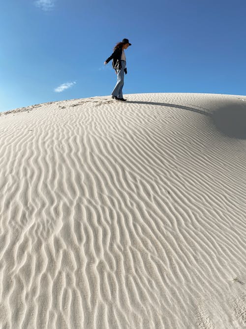 Woman Standing on Sand Dune