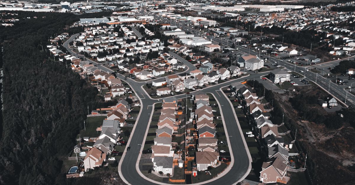 Aerial photo showcasing a suburban neighborhood with tree-lined streets and houses.