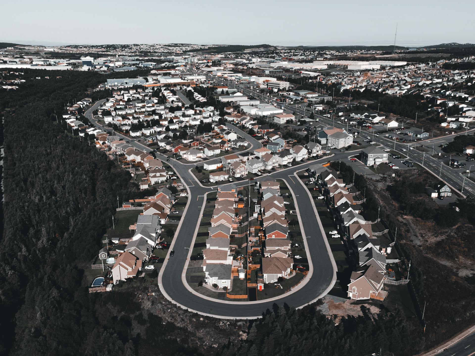 Aerial photo showcasing a suburban neighborhood with tree-lined streets and houses.