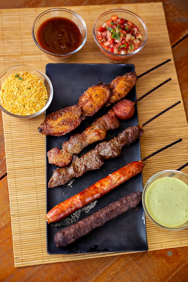 Traditional Meat Dish With Sauces On Table