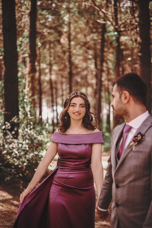 Woman in Dress and Man in Suit in Forest