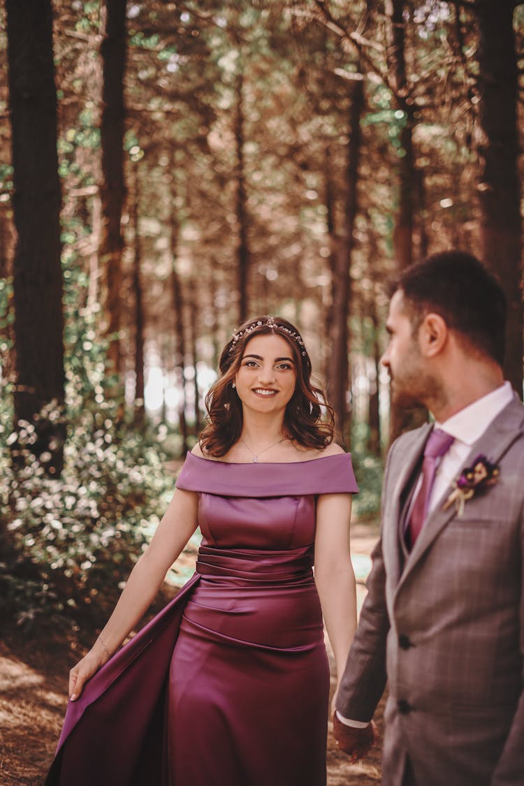 Woman In Dress And Man In Suit In Forest