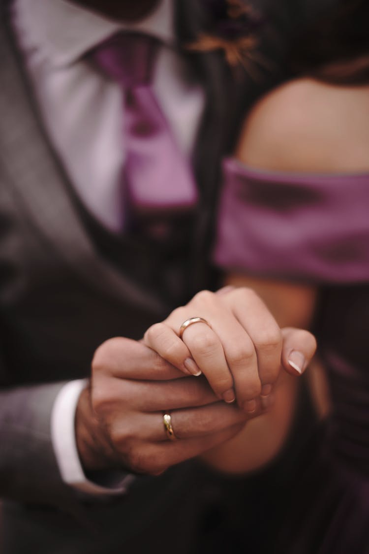 Close-Up Shot Of Husband And Wife Holding Hands