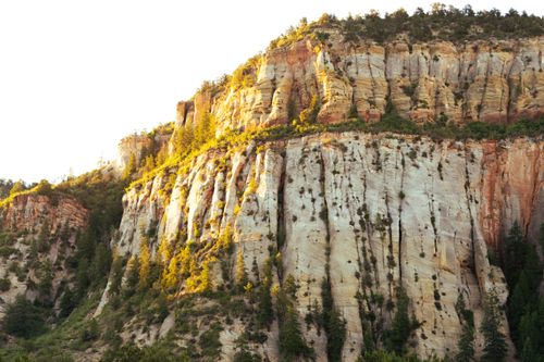 Free Sunlit cliffside in Arizona showcasing unique geological formations and vibrant natural colors. Stock Photo