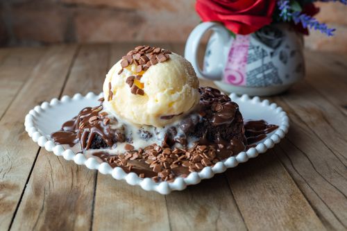 Free Indulge in a delicious chocolate brownie topped with vanilla ice cream and chocolate sprinkles. Stock Photo