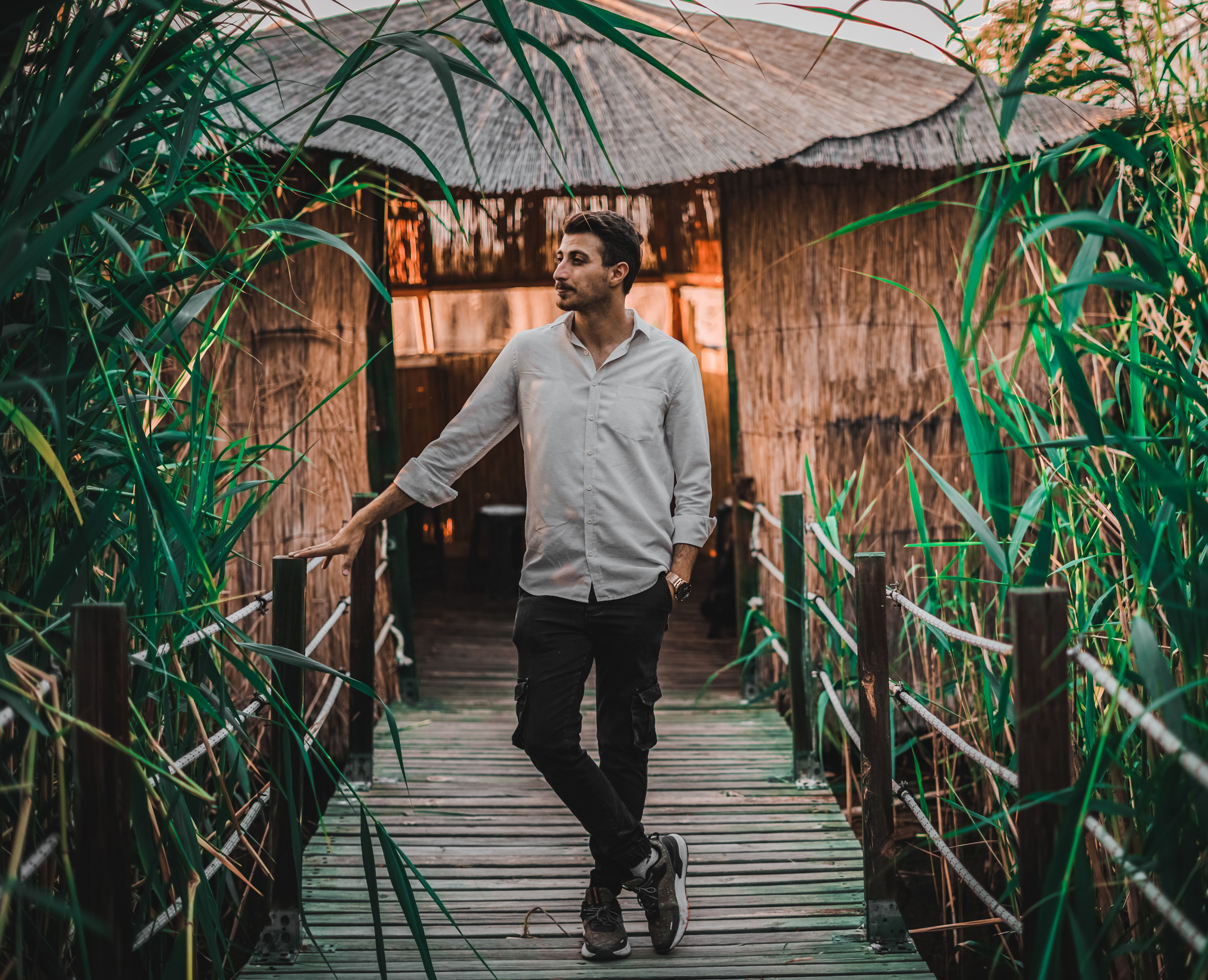 A Man Standing on a Wooden Bridge · Free Stock Photo