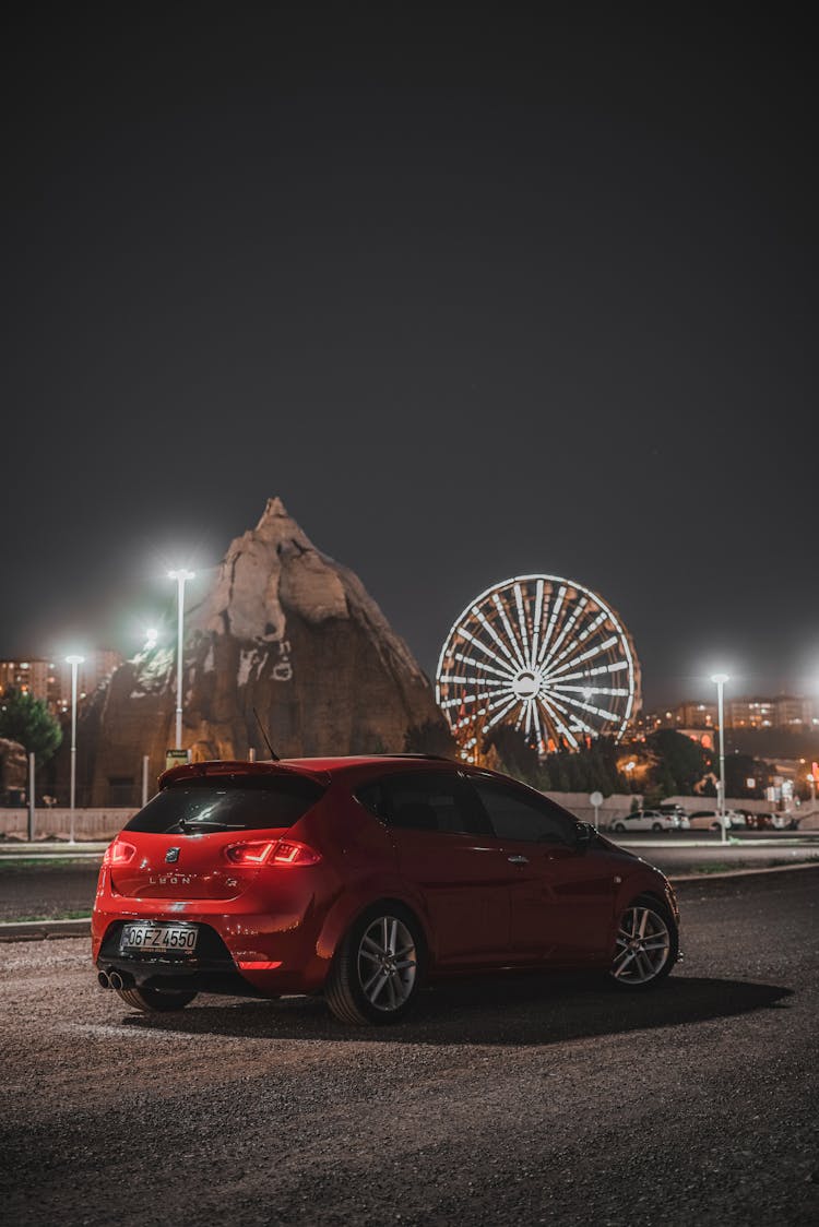 A Parked SEAT Leon Car On The Road During The Night