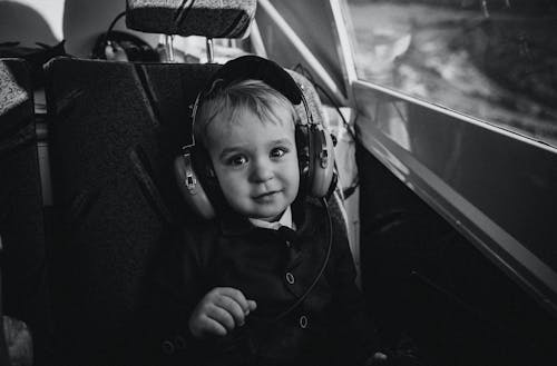 Monochrome Shot of a Boy Wearing Aviation Headset