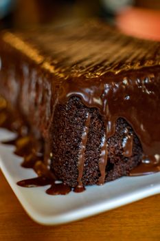 Close-up of a rich chocolate cake with syrup, perfect for dessert lovers.