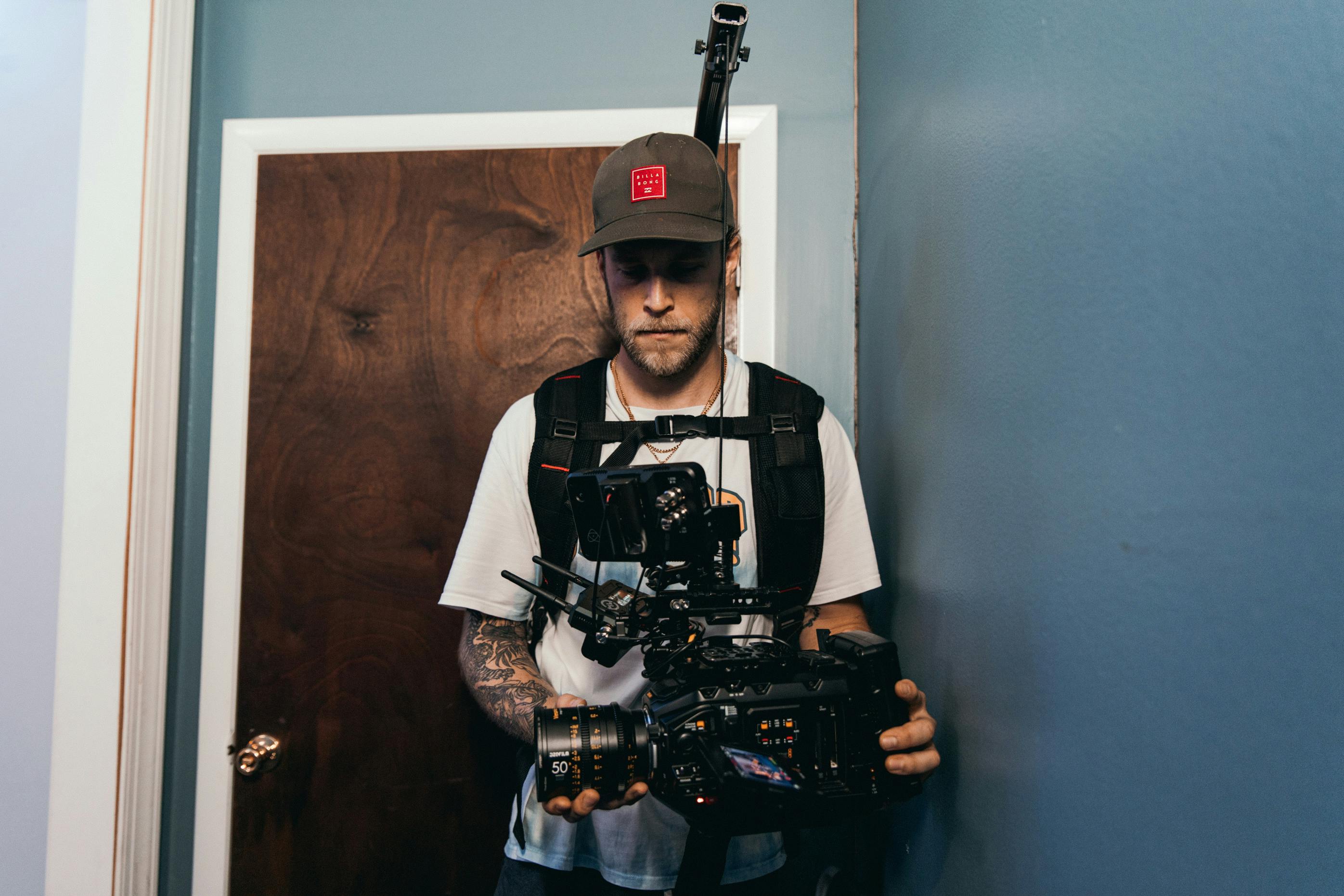 a cameraman recording using a camera near a door