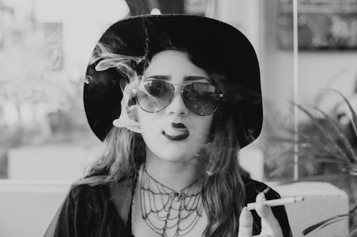 Monochrome Shot of Woman Smoking a Cigarette