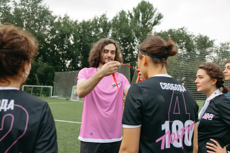 A Coach Giving Her Team Their Winning Medals