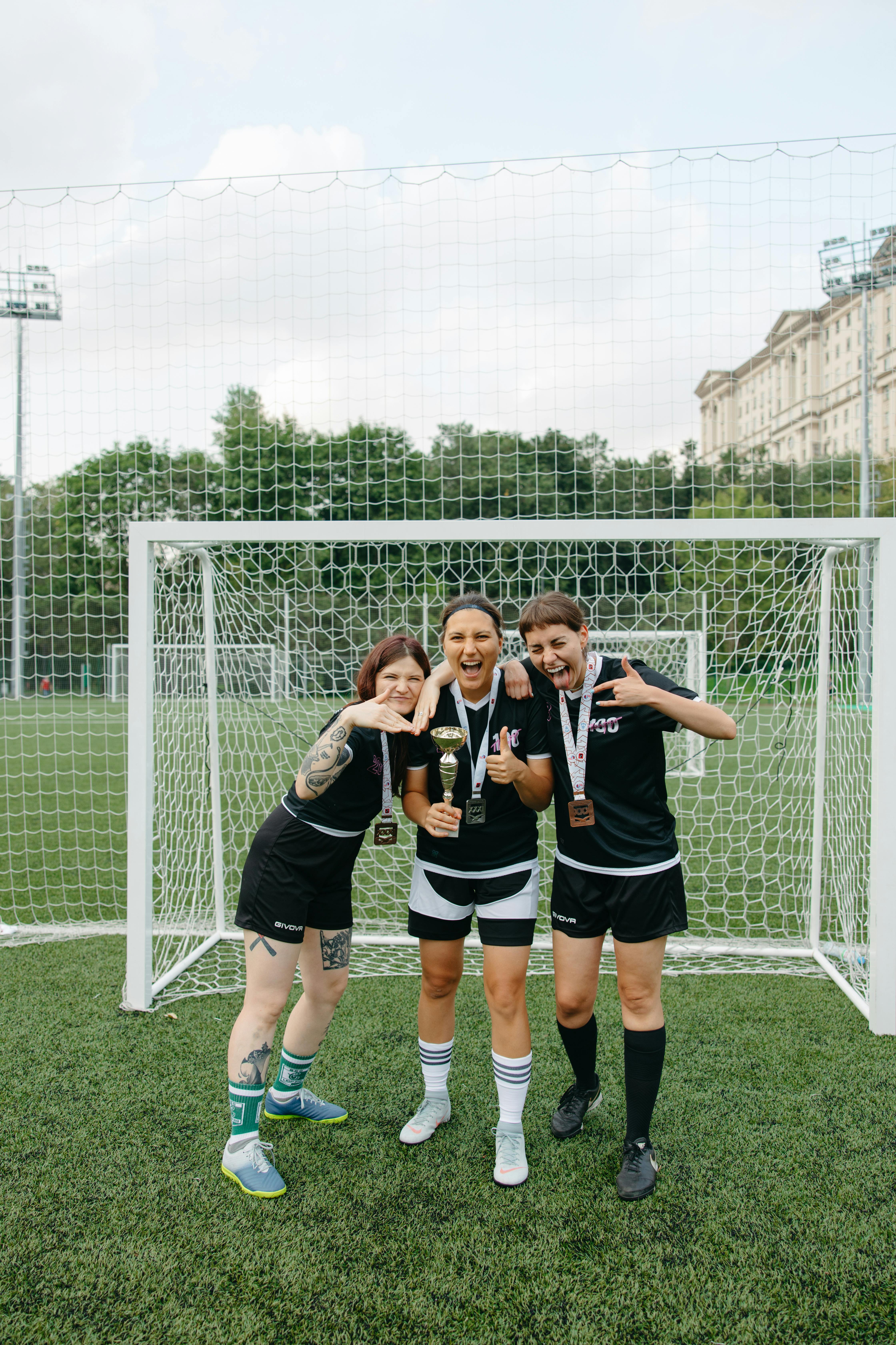 women standing near a soccer net