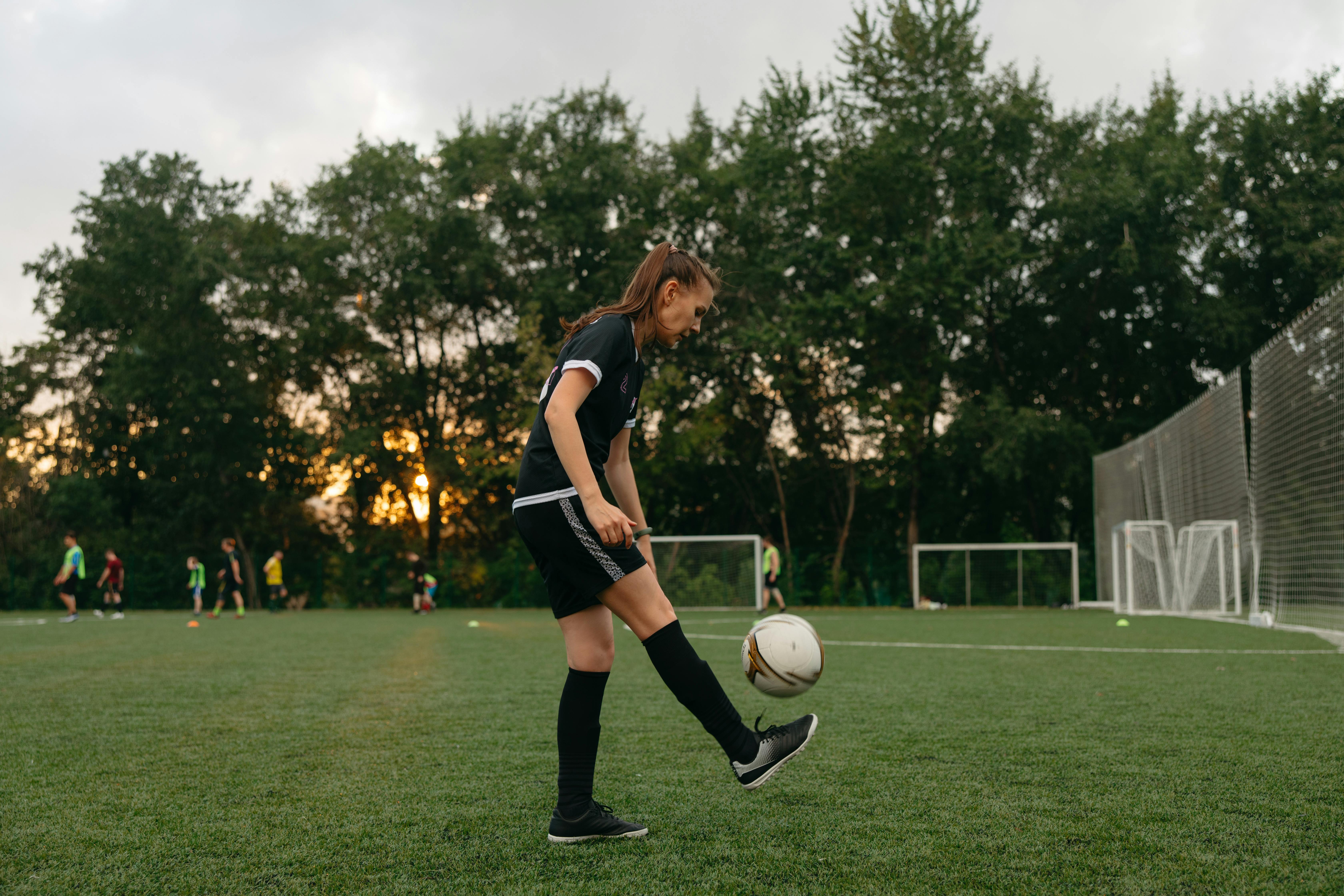 side view of a woman playing soccer