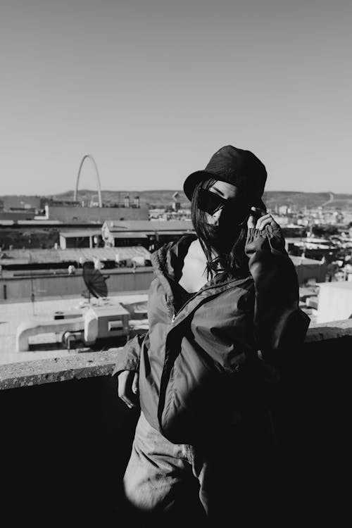 Free Grayscale Photo of Person Wearing a Jacket and Sunglasses Stock Photo