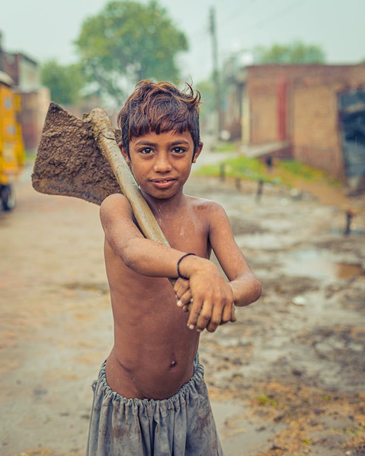 Shirtless Boy Holding Brown Wooden Hoe