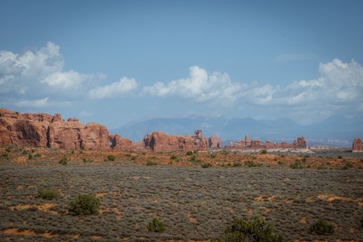 Explore the breathtaking red rock formations and vast landscapes of Arches National Park on a clear sunny day.