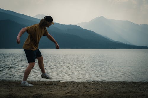 Man Throwing Rock into Lake