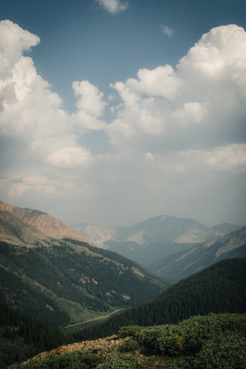 Free Green Mountains Under White Clouds Stock Photo