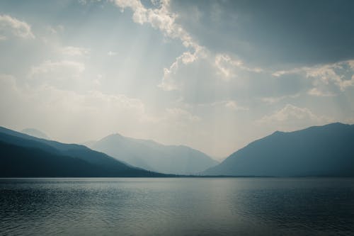 A Lake Near the Mountains Under a Cloudy Sky