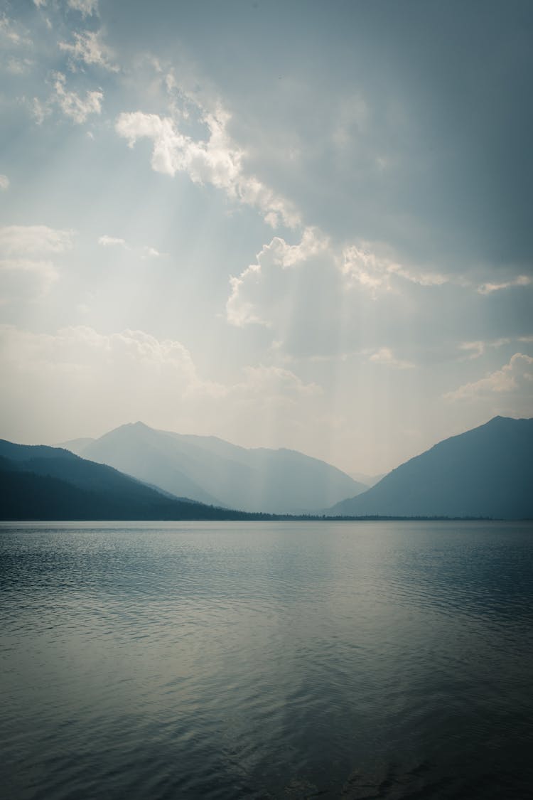 Beautiful View Of Lake In Mountains Illuminated By Sunbeams