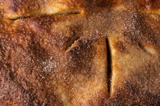 A detailed close-up of a freshly baked cinnamon sugar pie crust.