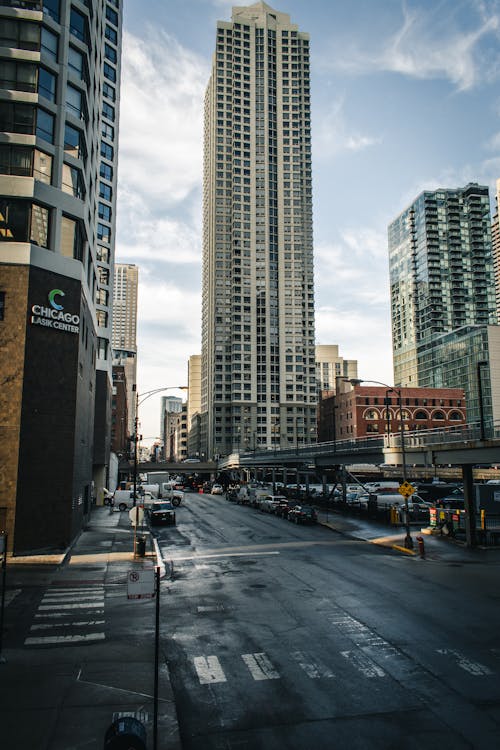 Cars on Road Near High Rise Buildings