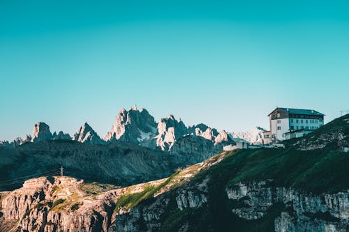 White and Brown Building on Top of Mountain