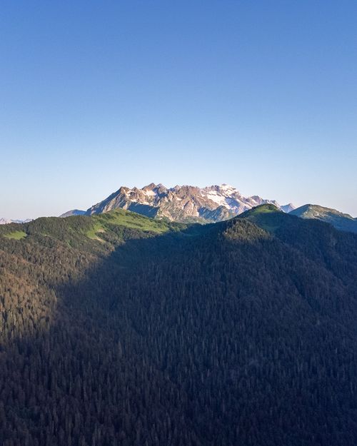 Free Stunning aerial view capturing expansive mountain ranges under a clear blue sky. Stock Photo