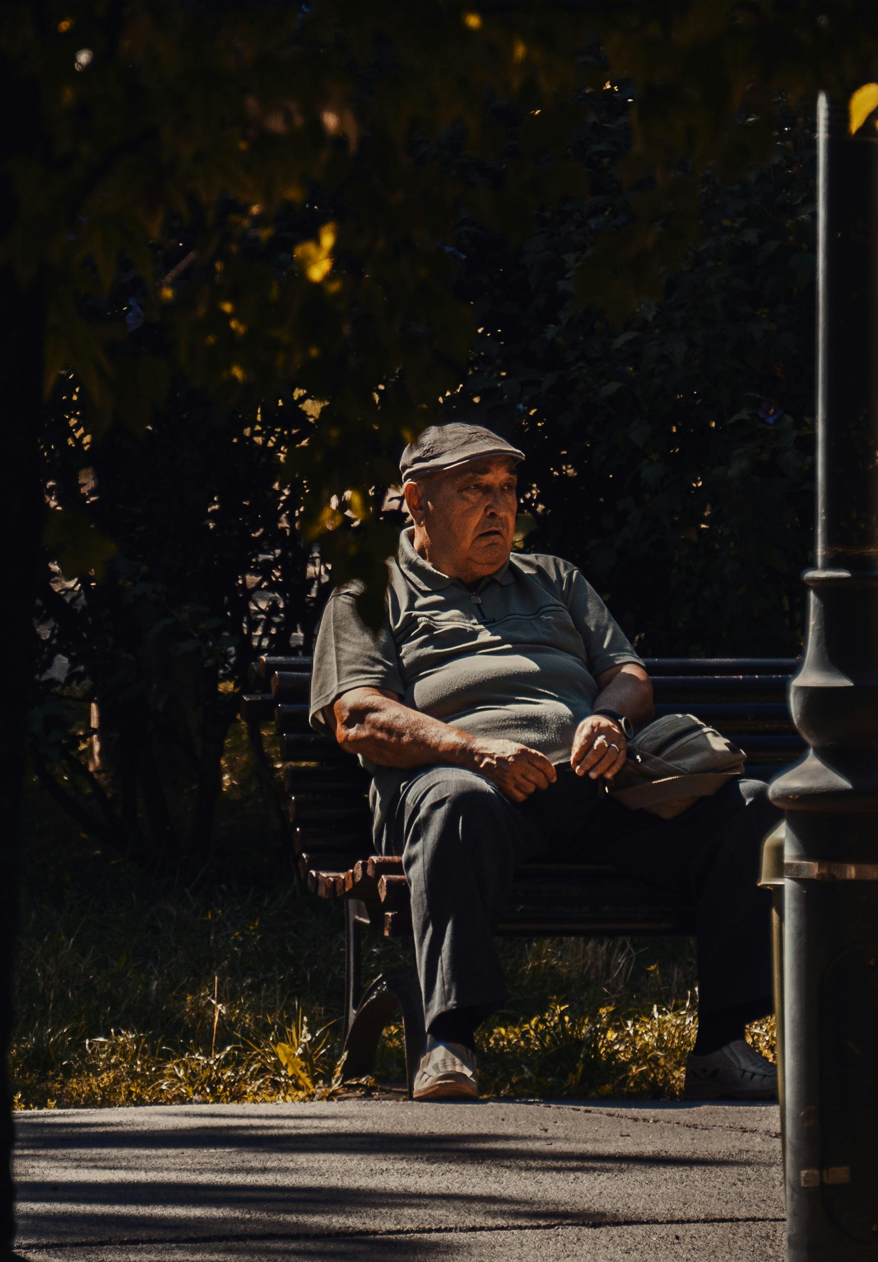 Elderly Man in a Face Mask Sitting on a Bench · Free Stock Photo