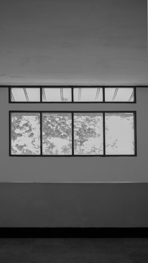 Grayscale Photo of Windows inside a Building