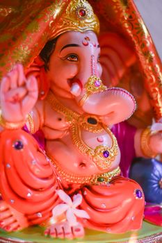 A colorful close-up of a Lord Ganesh statue, symbolizing Hindu spirituality.