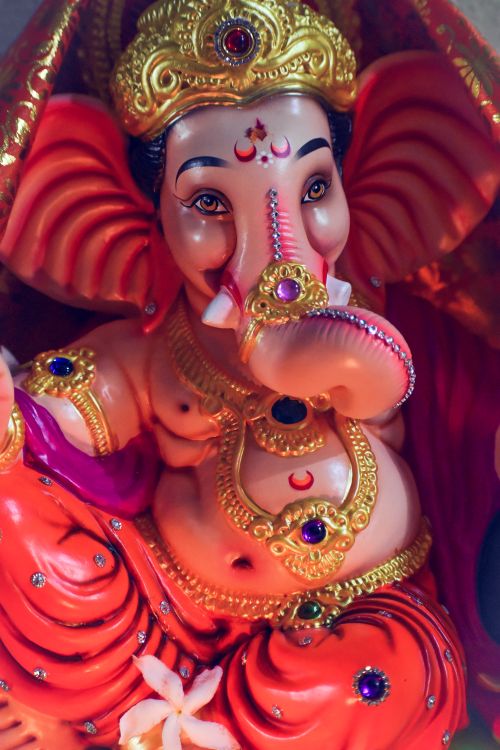 Free Colorful Ganesh idol showcasing detailed craftsmanship and cultural symbolism. Stock Photo