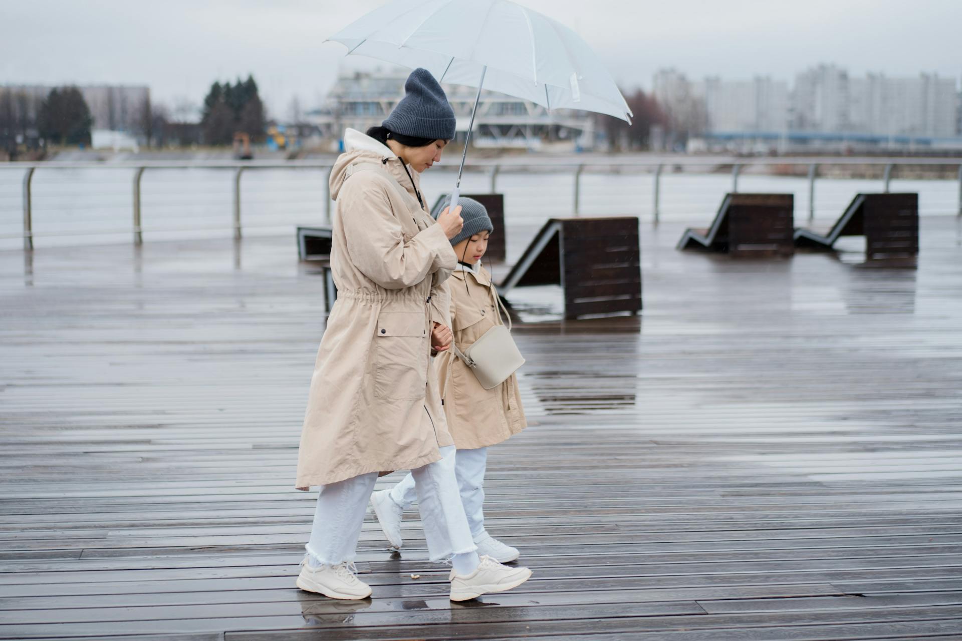 A Mother and Daughter using an Umbrella